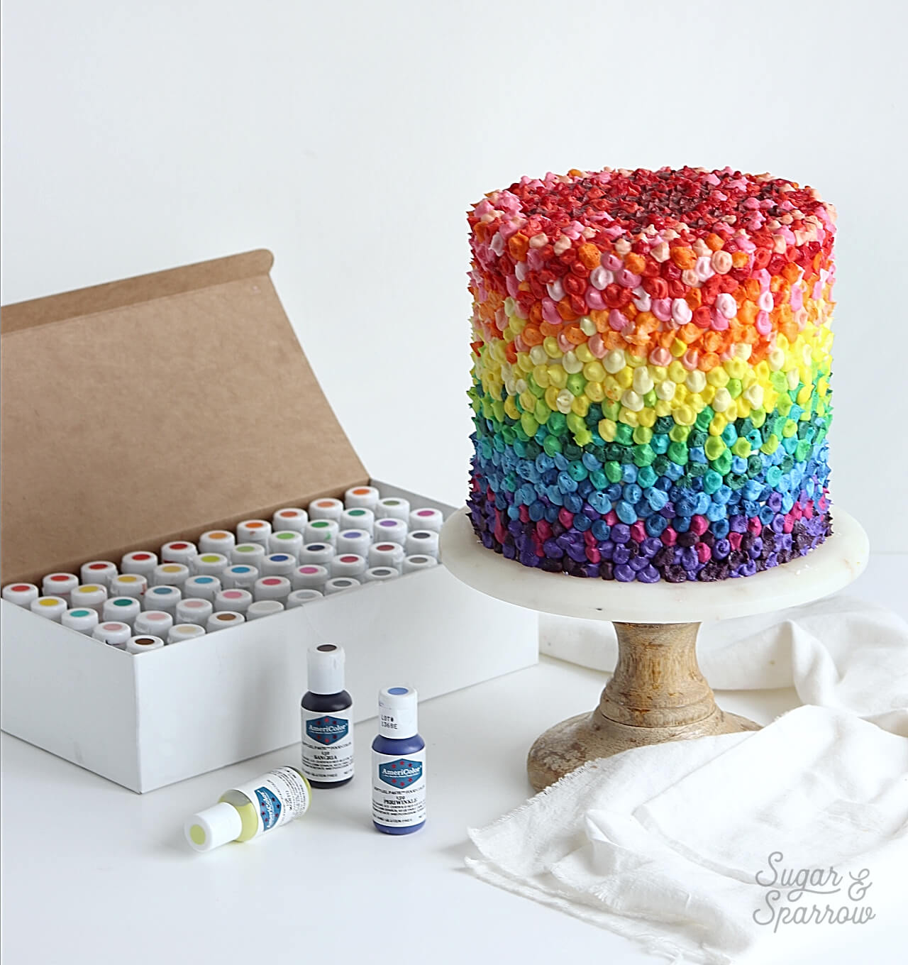 rainbow buttercream cake by sugar and sparrow