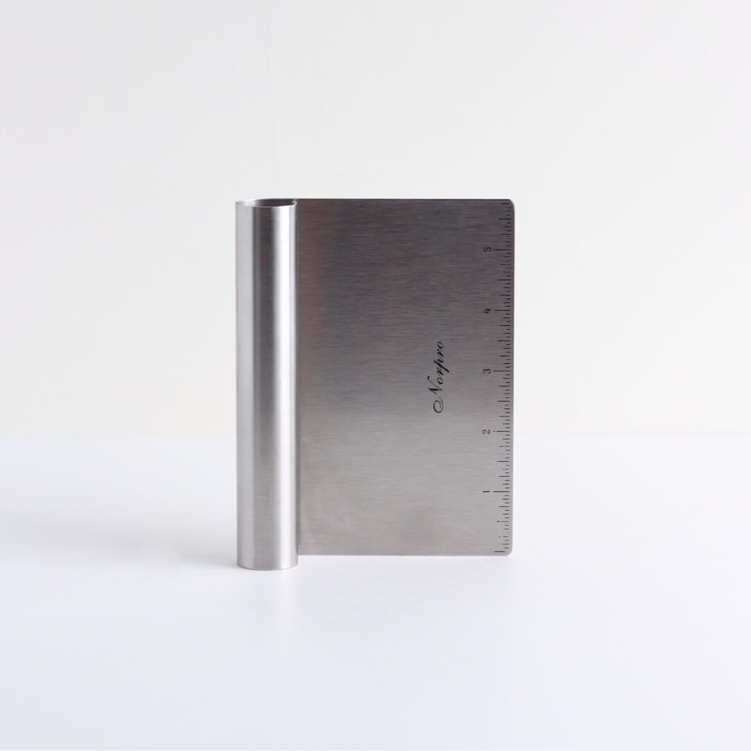 A 6-inch metal bench scraper sits on a white background.