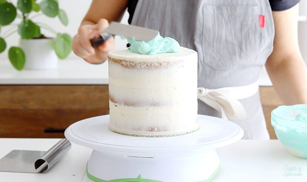 frosting a cake with buttercream