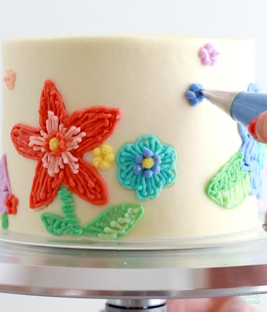 piping floral embroidery with buttercream