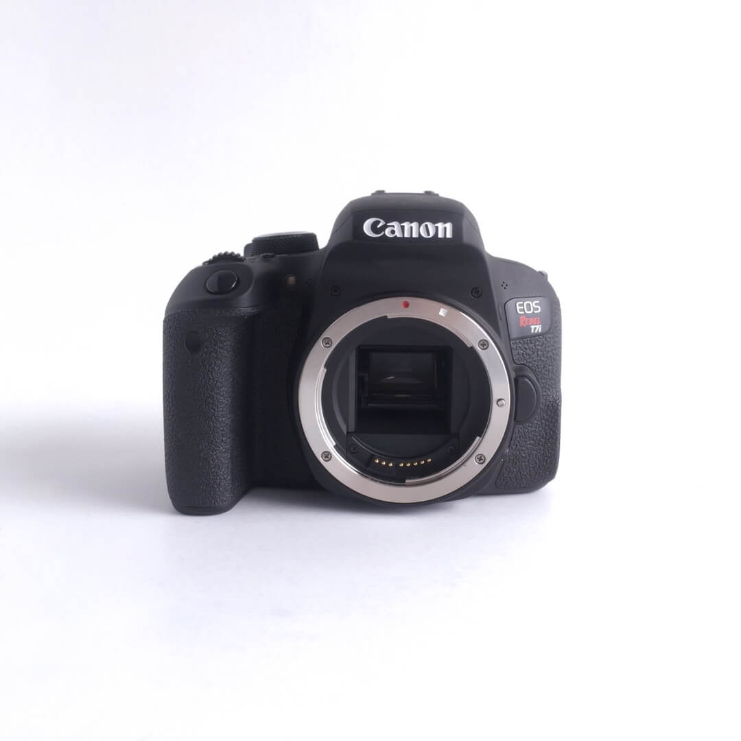 A Canon T7i body sits on a white backround.