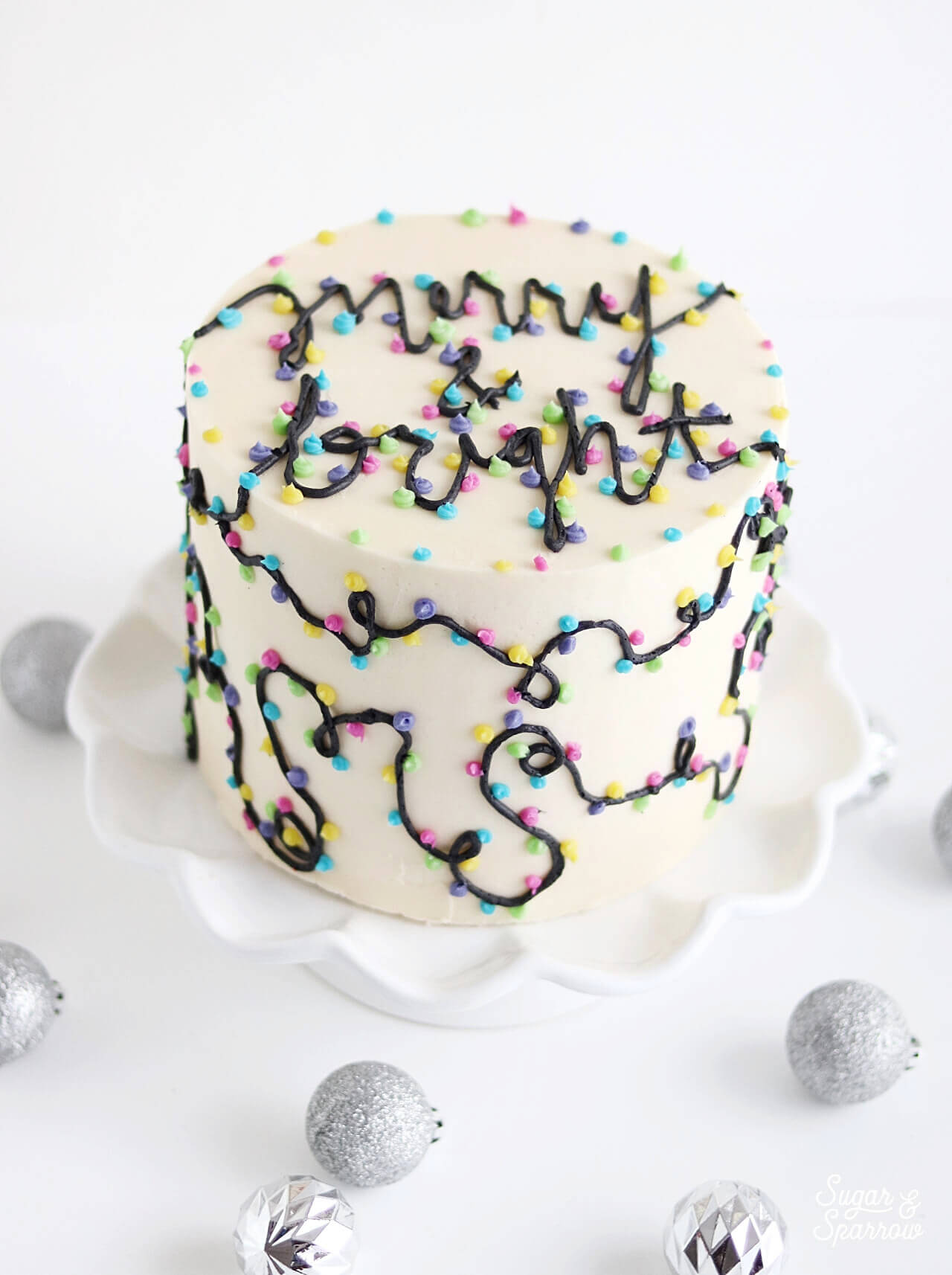 merry and bright christmas lights cake by sugar and sparrow