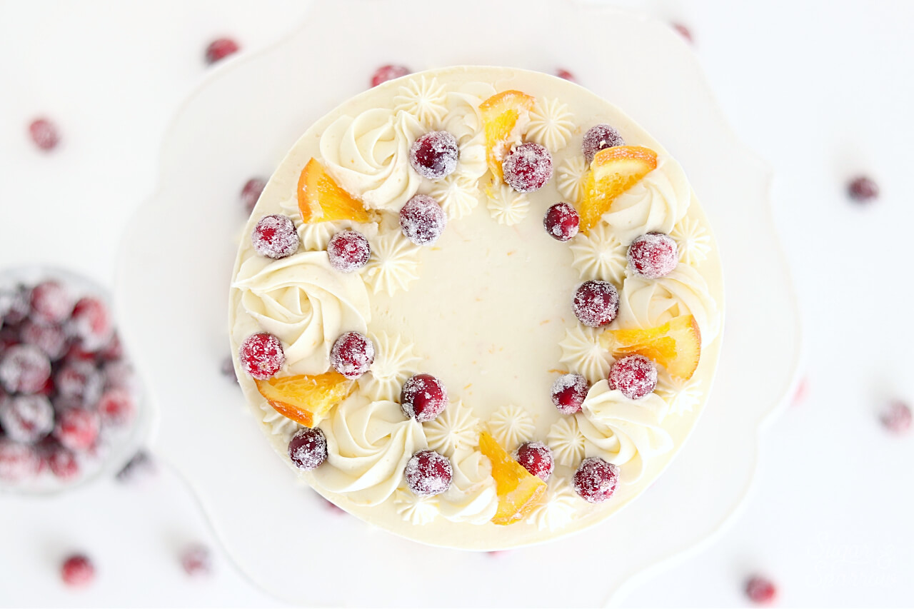 piped buttercream cake with cranberries and oranges