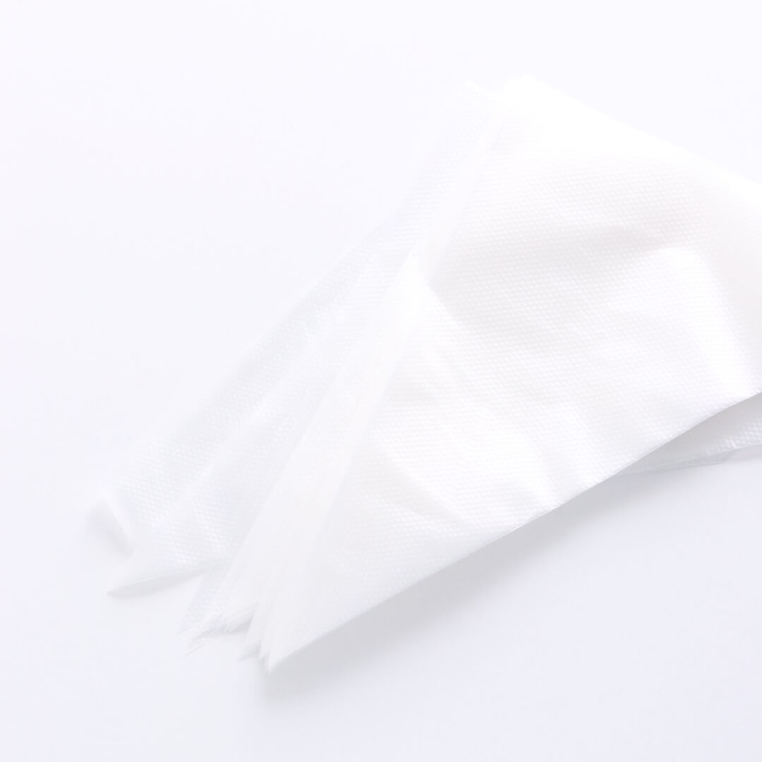 A stack of disposable piping bags sits on a white background.