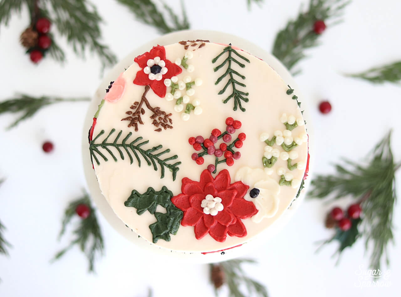 buttercream cake with holiday flowers by sugar and sparrow