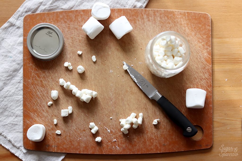 decorating a cake with marshmallows