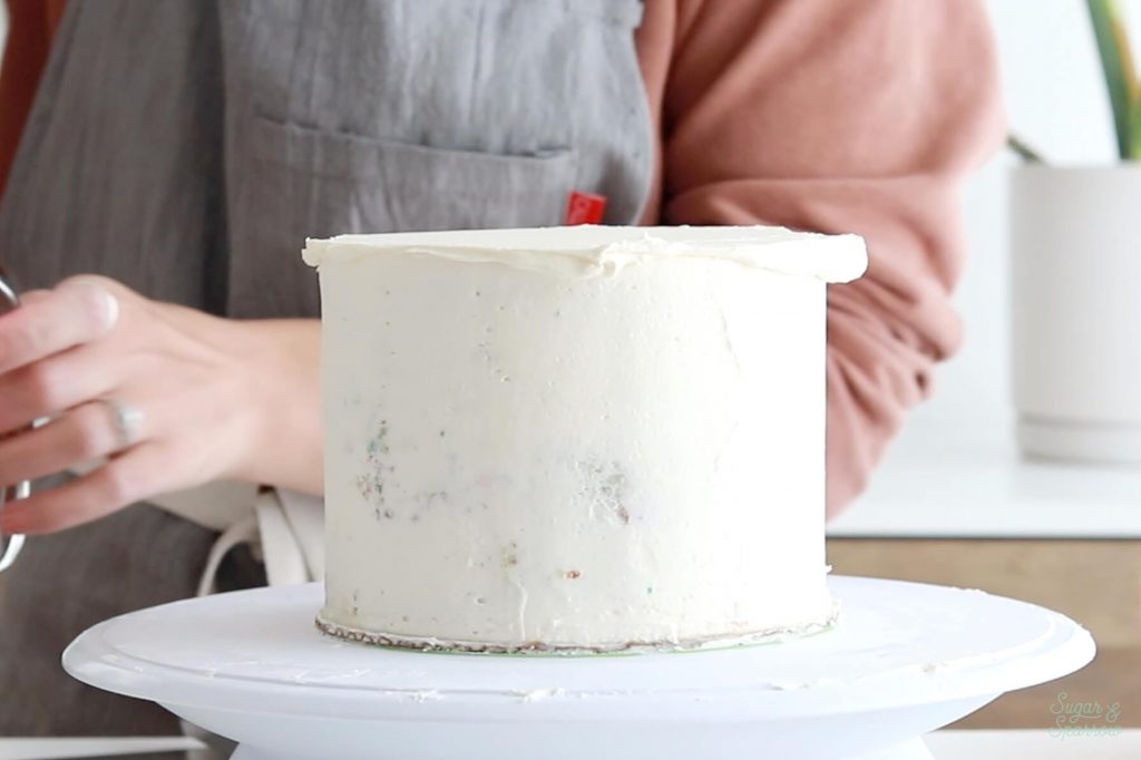 frosting a cake with buttercream