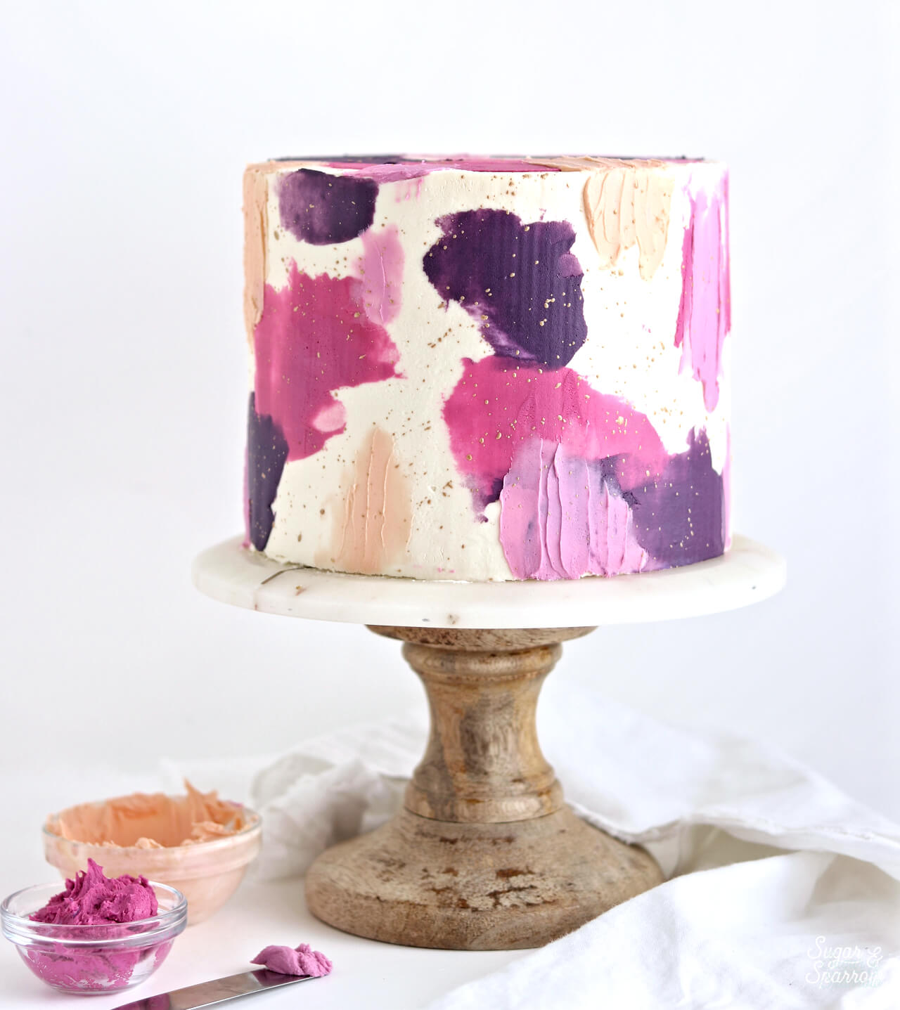 colorful buttercream cake by sugar and sparrow