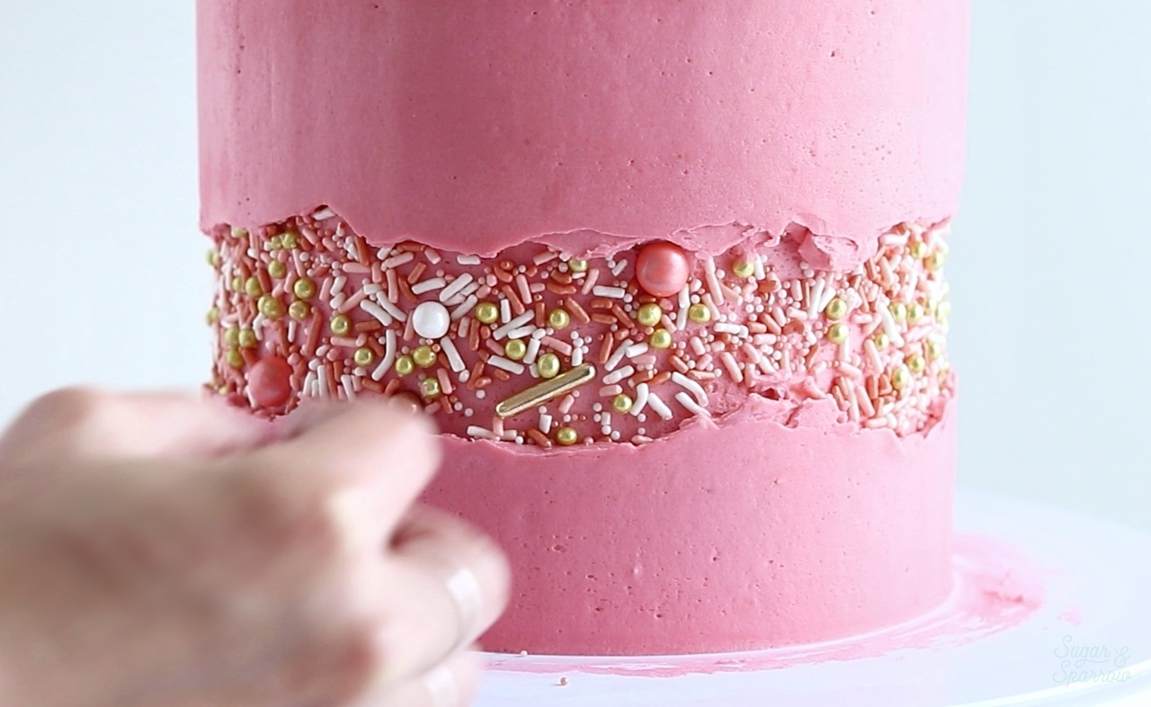 Adding sprinkles to fault line cake