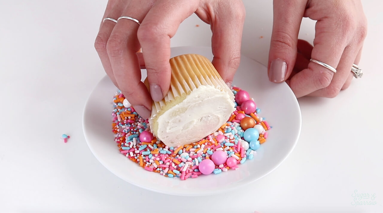 dipping cupcakes in sprinkles