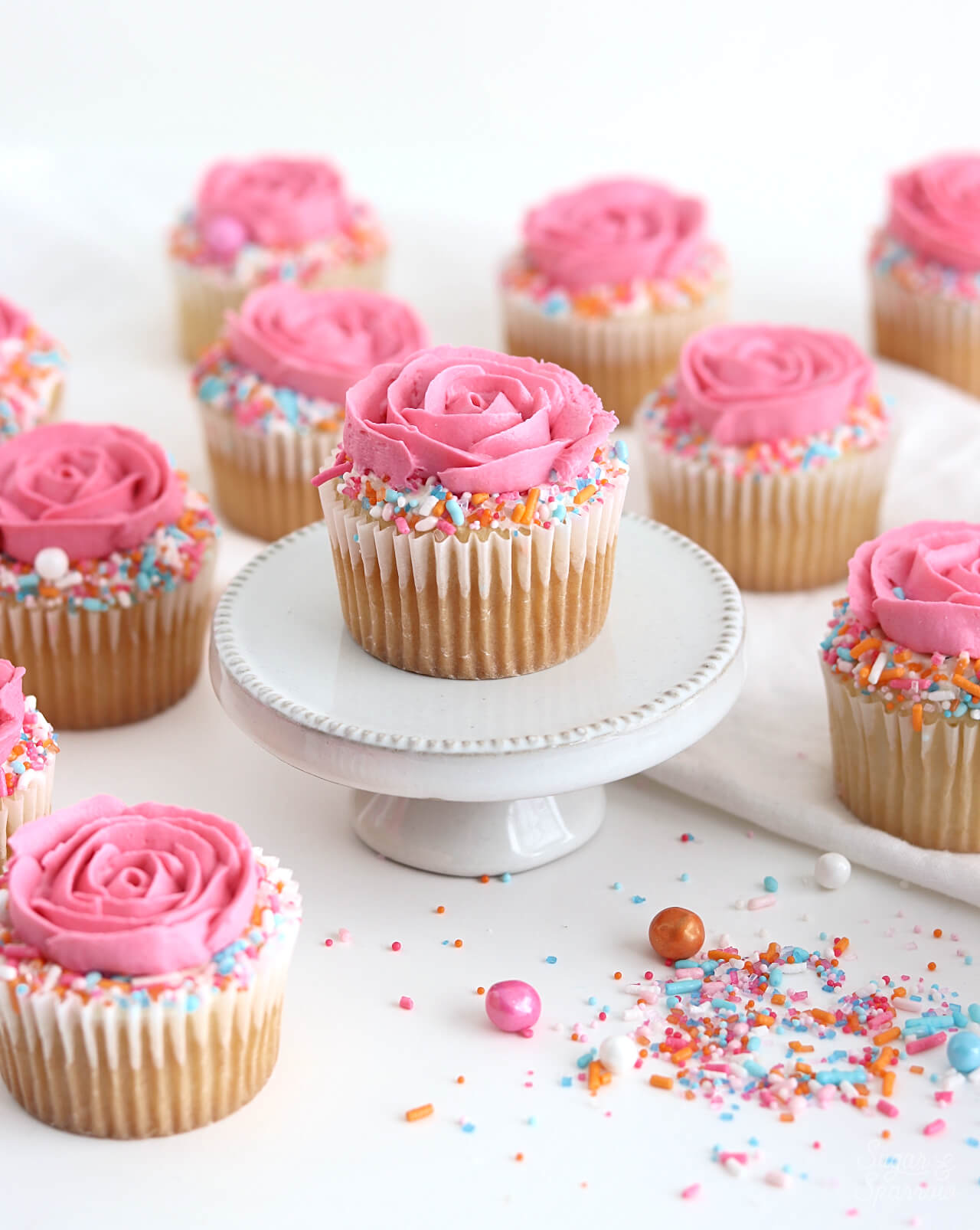 rose cupcakes with sprinkles by sugar and sparrow