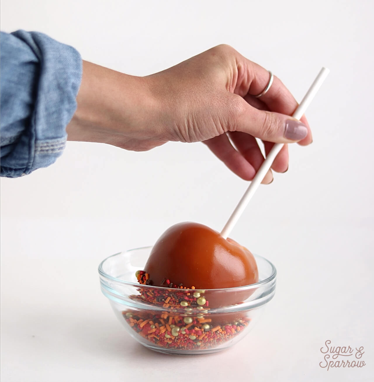 dipping caramel apples into sprinkles by SprinklePop