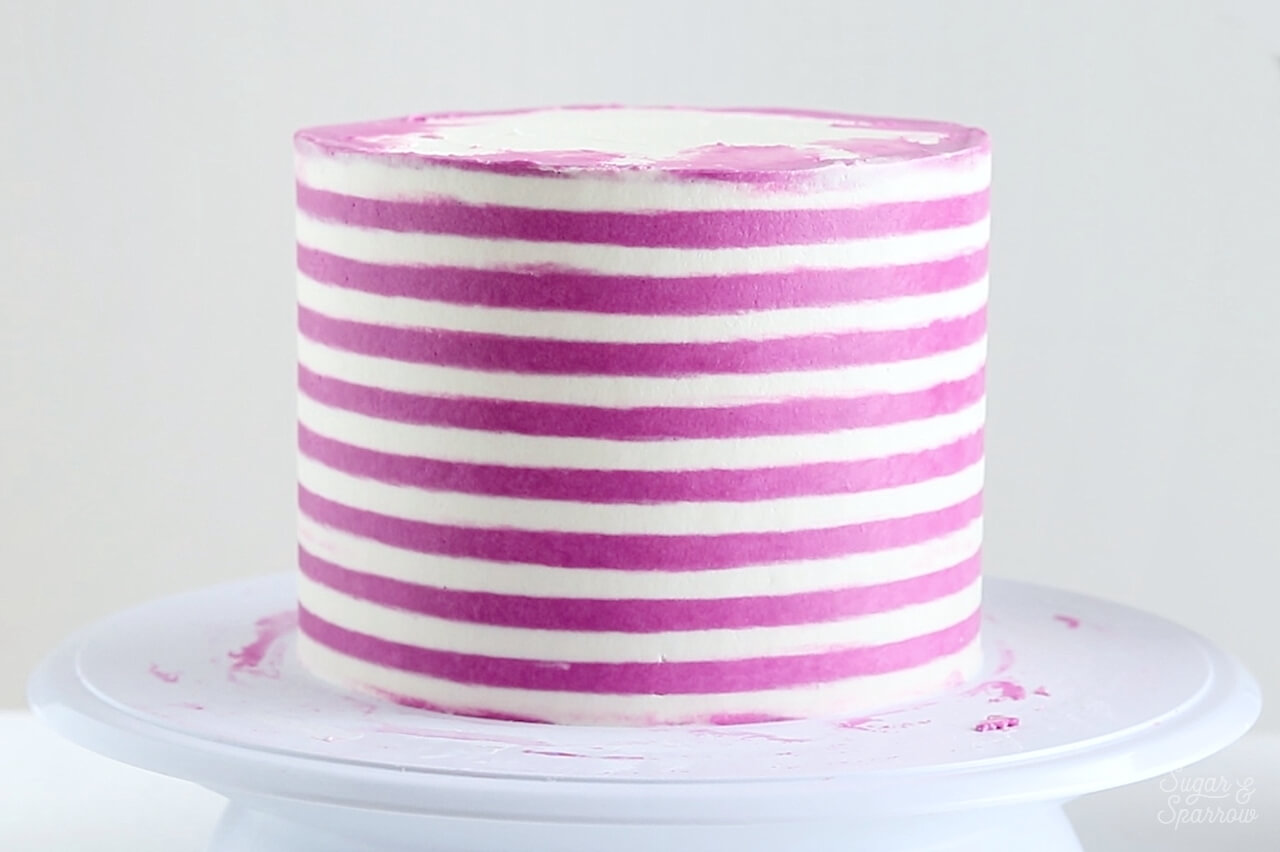 striped buttercream cake by sugar and sparrow