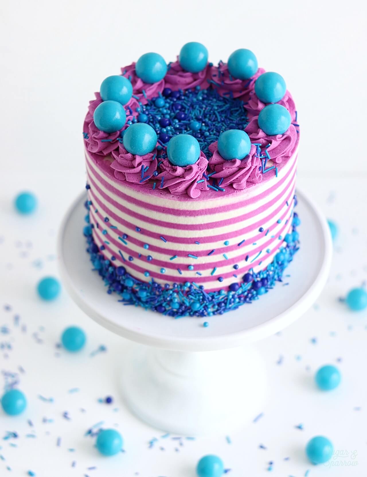 striped cake with sprinkles and gum balls