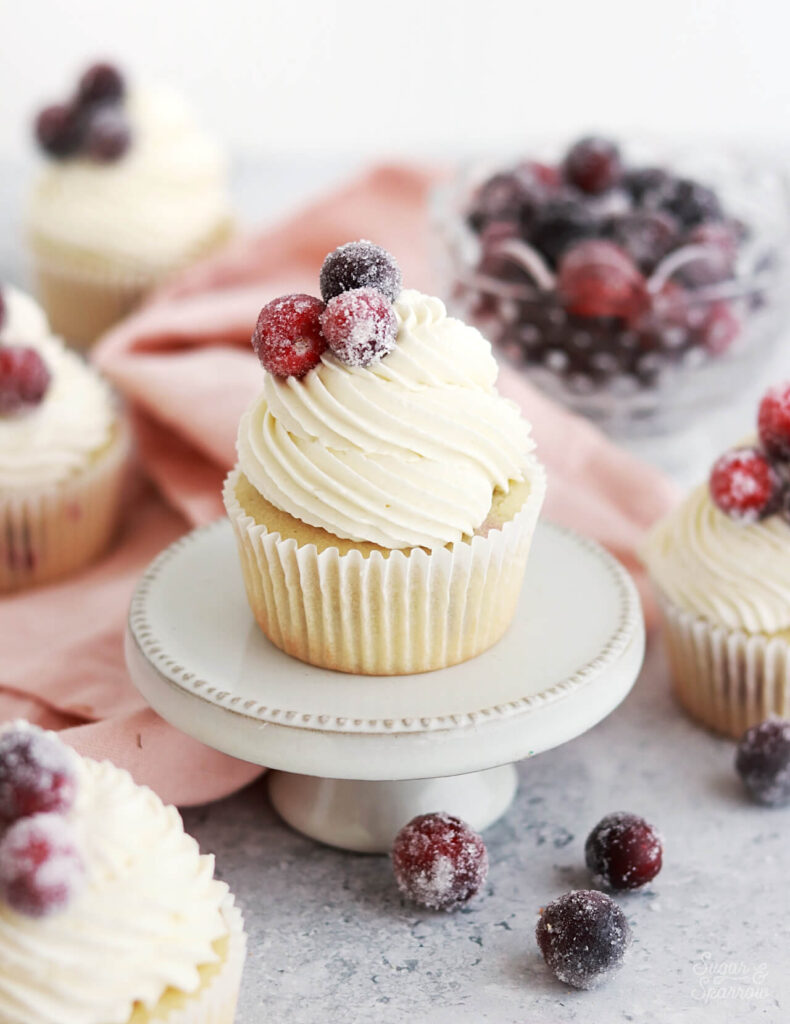 cranberry vanilla cupcakes with white chocolate frosting and sugared cranberries