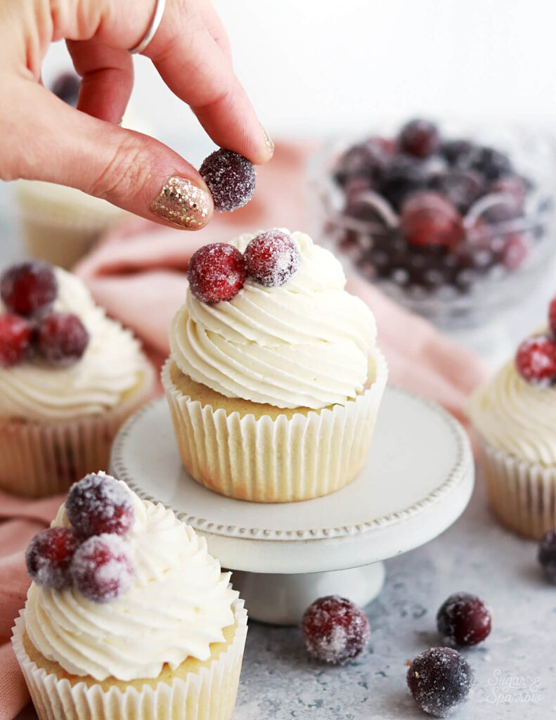 sugared cranberries on cupcakes by sugar and sparrow