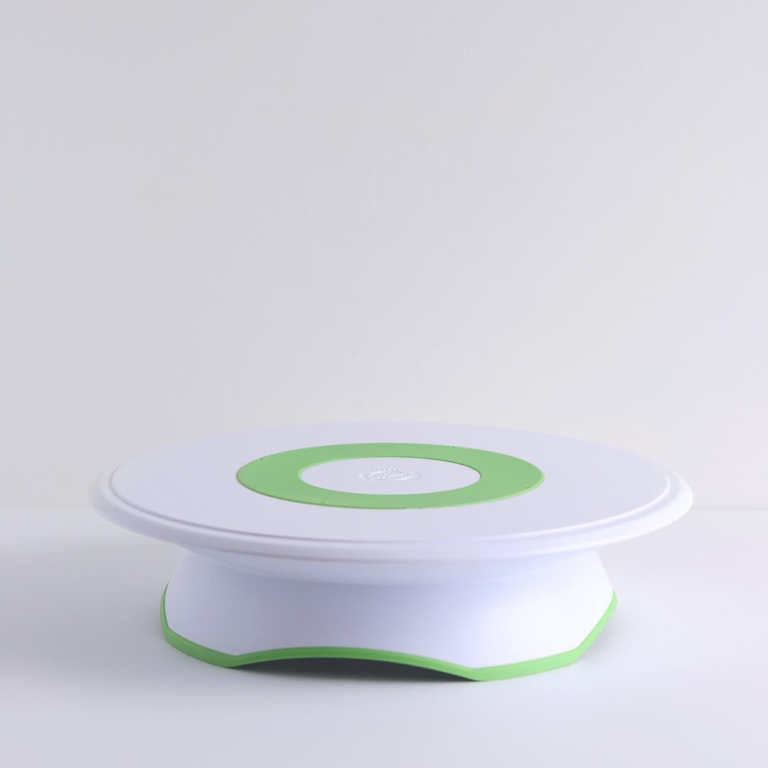 A white Wilton turntable with lime green accents sits on a white background.