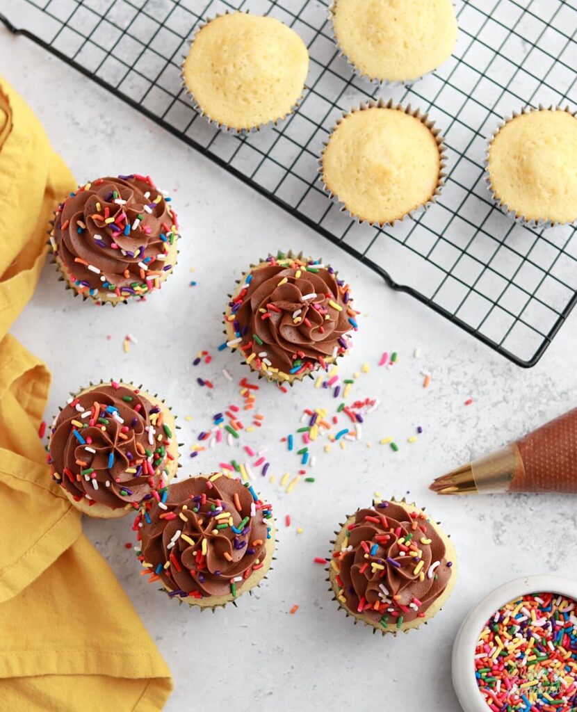 classic yellow cupcakes with chocolate frosting recipe by sugar and sparrow
